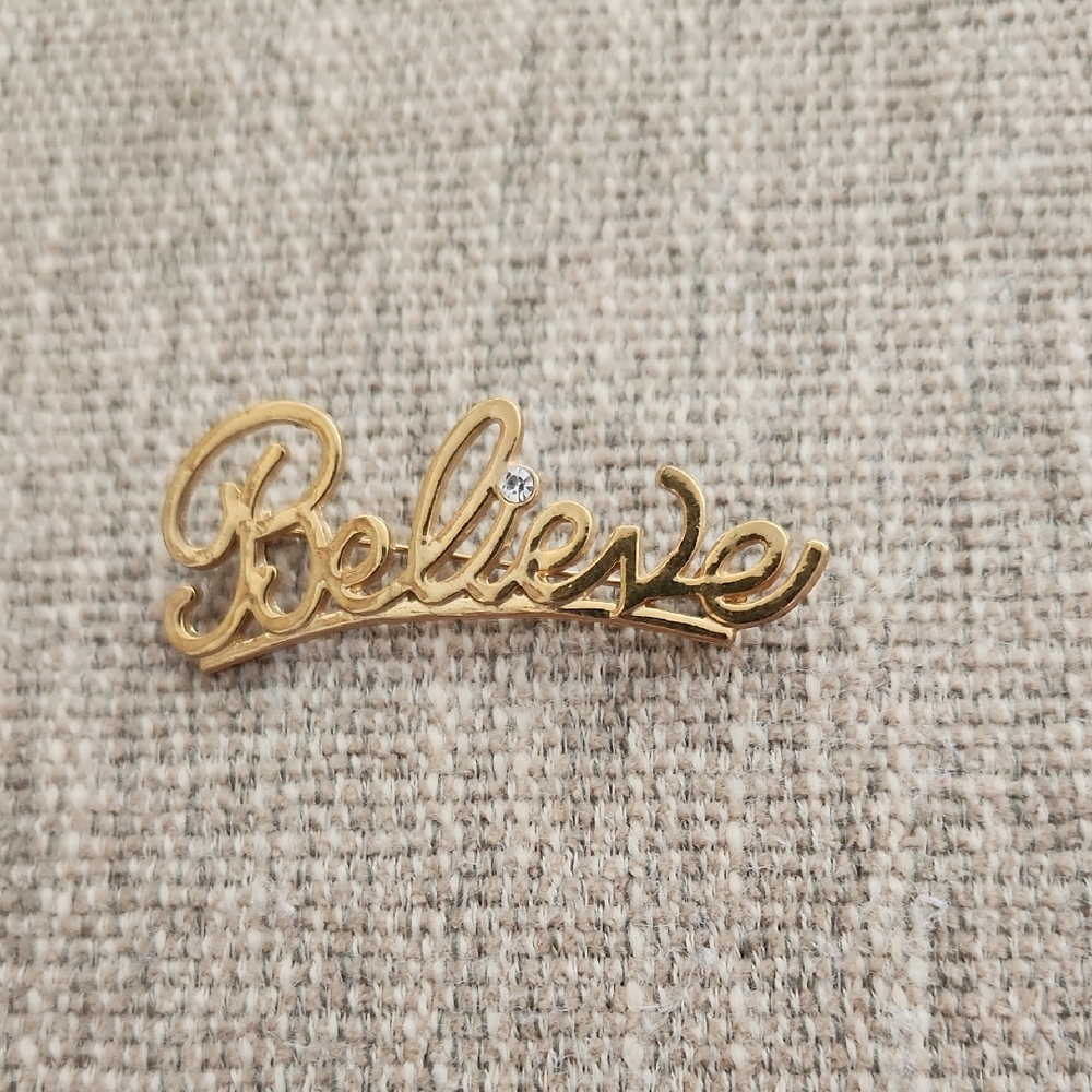 Avon Gold "Believe" Script Brooch with Clear Rhinestone